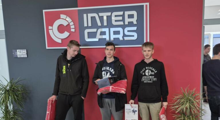 Prejemniki priznanj ob predstavitvenem panoju Inter Cars.